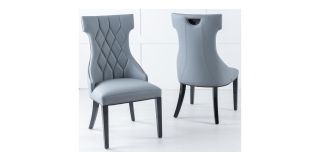 Tremiti Pair Of Grey Leather Quilted Dining Chairs With Black Lacquer Legs And Details